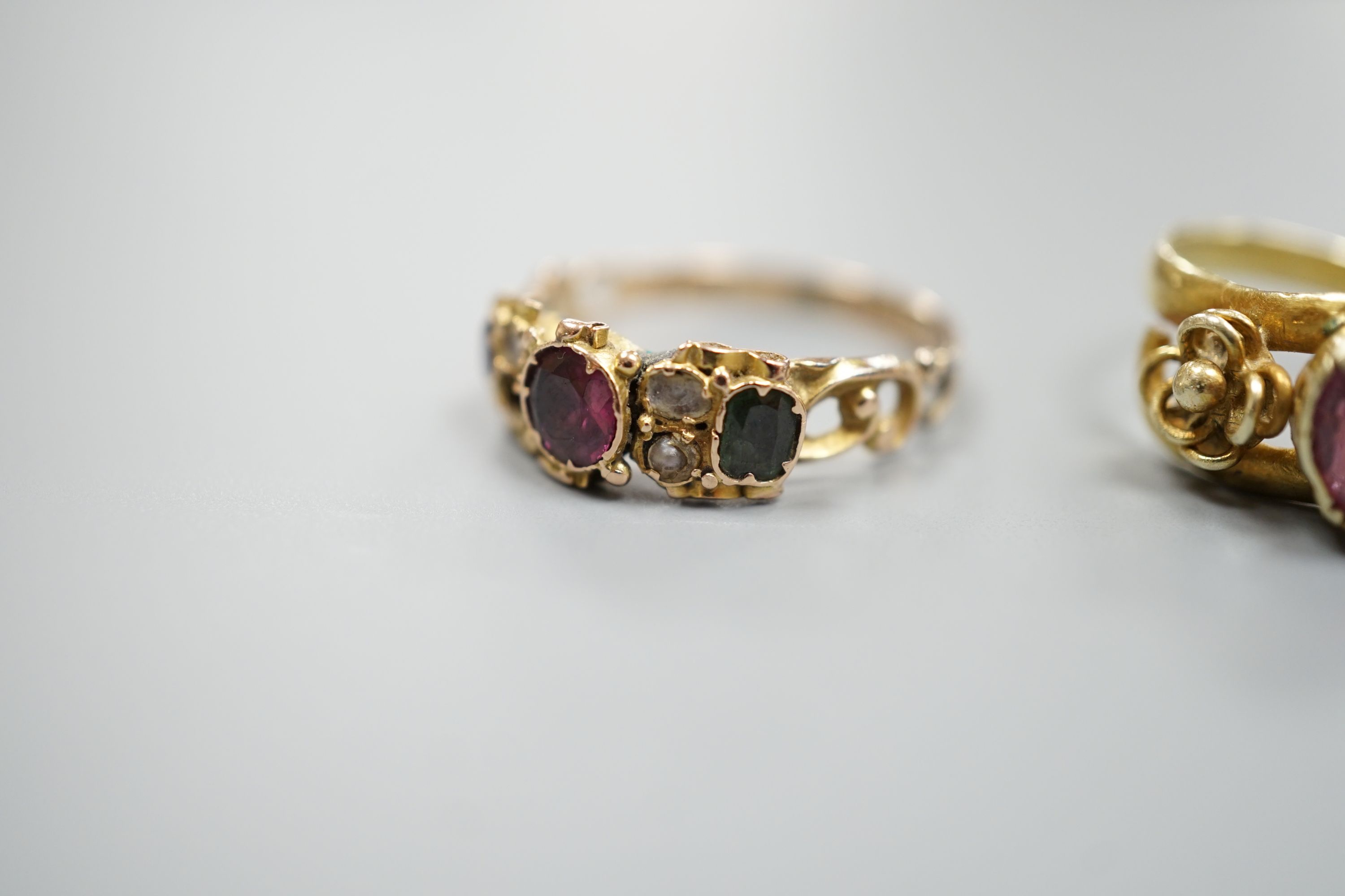 A Victorian gold, garnet and seed pearl set dress ring, size N/O and a yellow metal and garnet set ring, gross 5 grams.